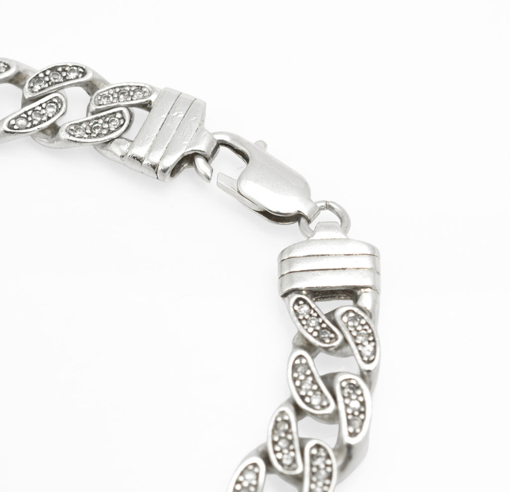 Vintage sterling silver CZ set curb chain bracelet laid flat, full length showing lobster clasp and overall form