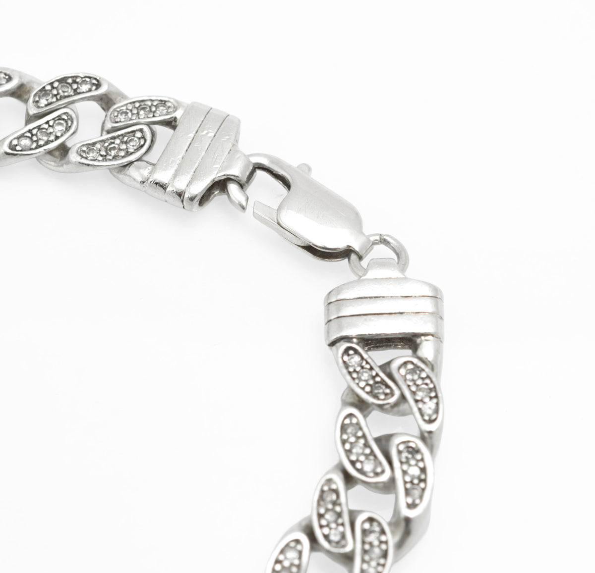 Vintage sterling silver CZ set curb chain bracelet laid flat, full length showing lobster clasp and overall form