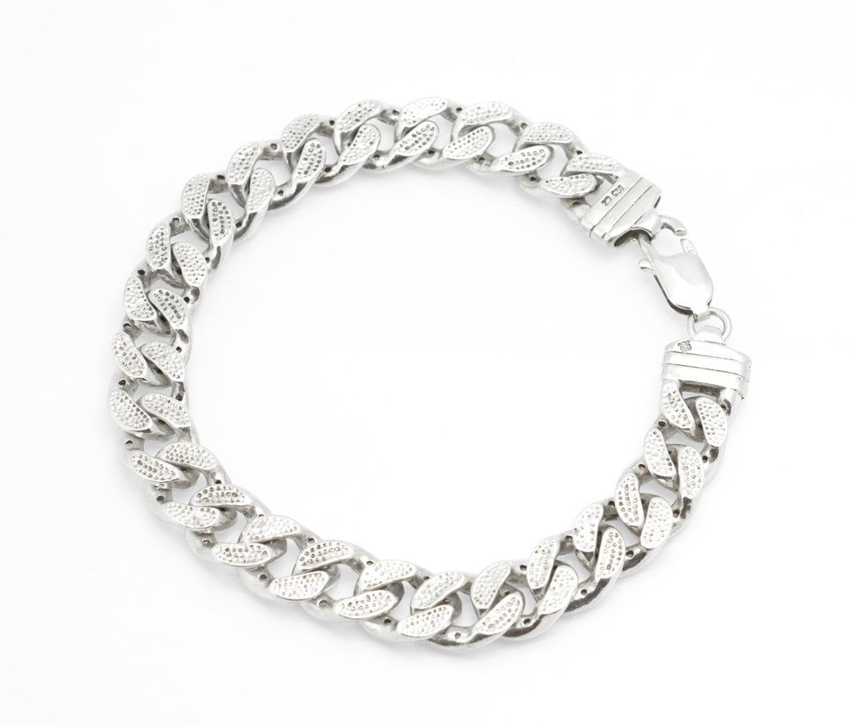 Vintage sterling silver CZ curb chain bracelet worn on wrist, showing scale and fit against dark sleeve