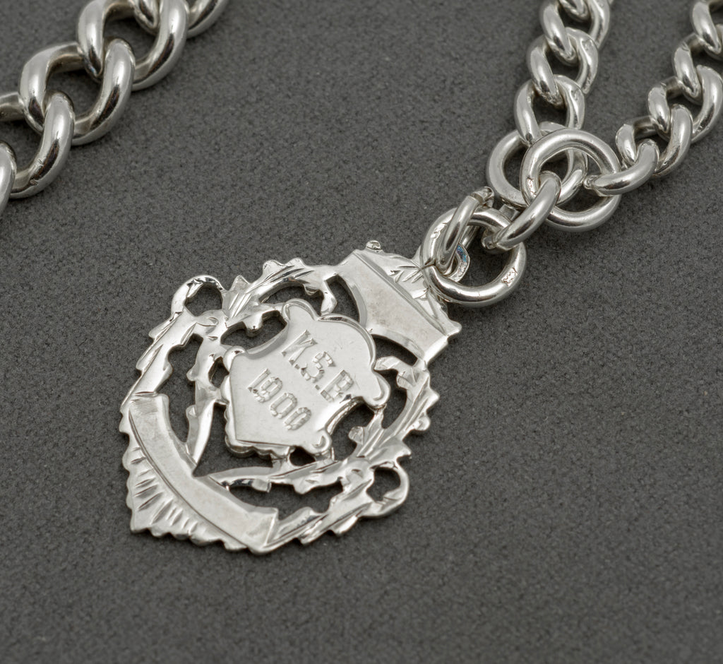 Antique sterling silver Albert chain fob close up showing pierced open work and engraved K.S.B 1900 to shield cartouche, Birmingham 1899 James Fenton and Co