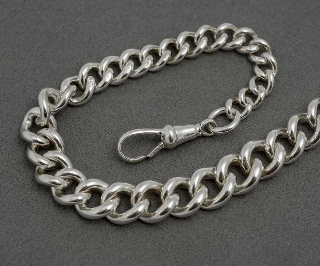 Antique sterling silver Albert watch chain full length coiled view showing graduated curb links and dog clip, Chester 1902