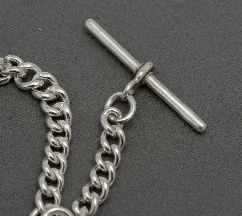 Antique sterling silver Albert chain fob reverse showing Birmingham 1899 hallmarks and maker's mark for James Fenton and Co
