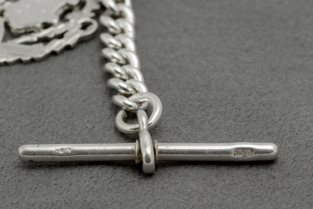 Antique sterling silver Albert watch chain close up of graduated curb links showing lion passant marks and Chester hallmark to central link