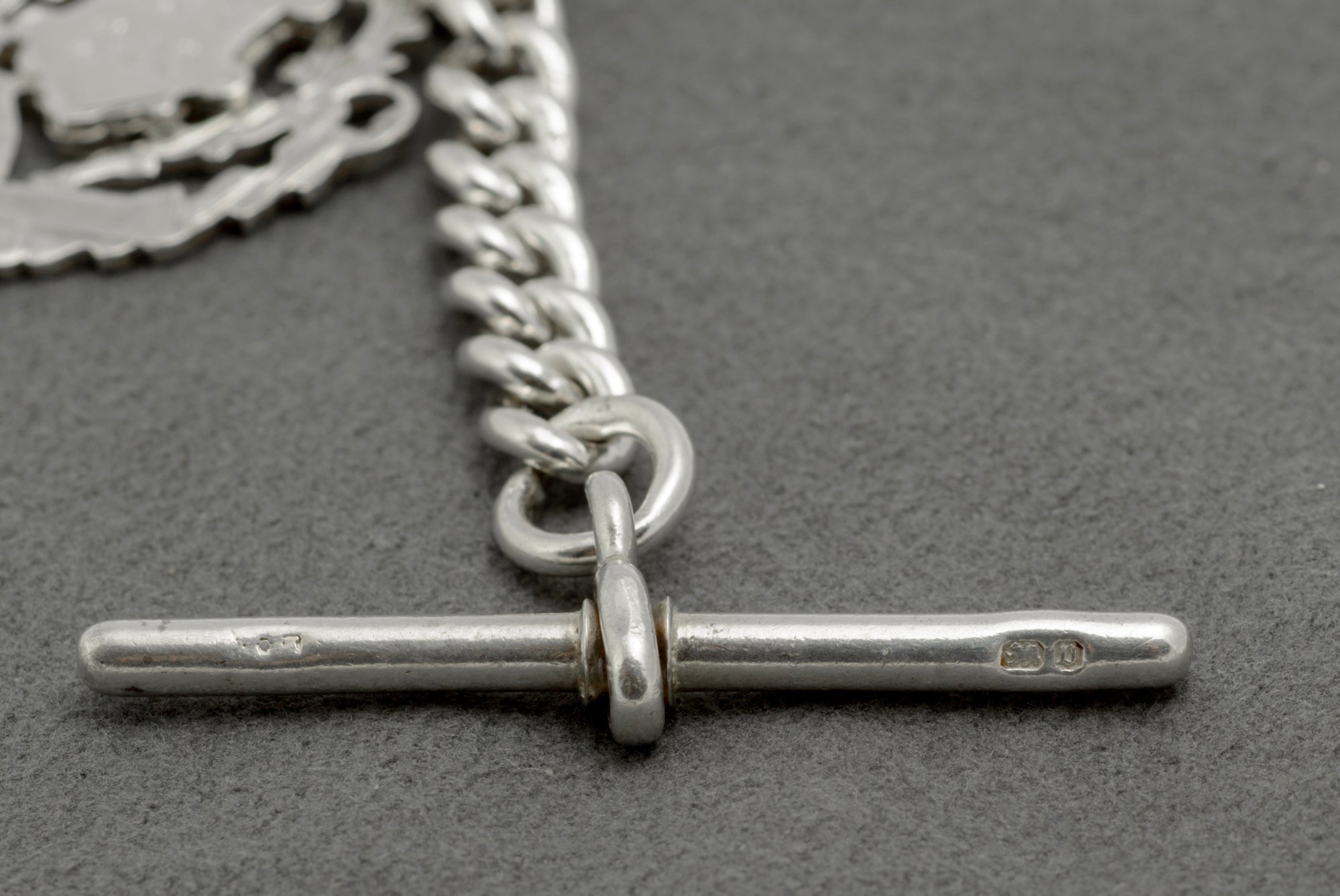 Antique sterling silver Albert watch chain close up of graduated curb links showing lion passant marks and Chester hallmark to central link