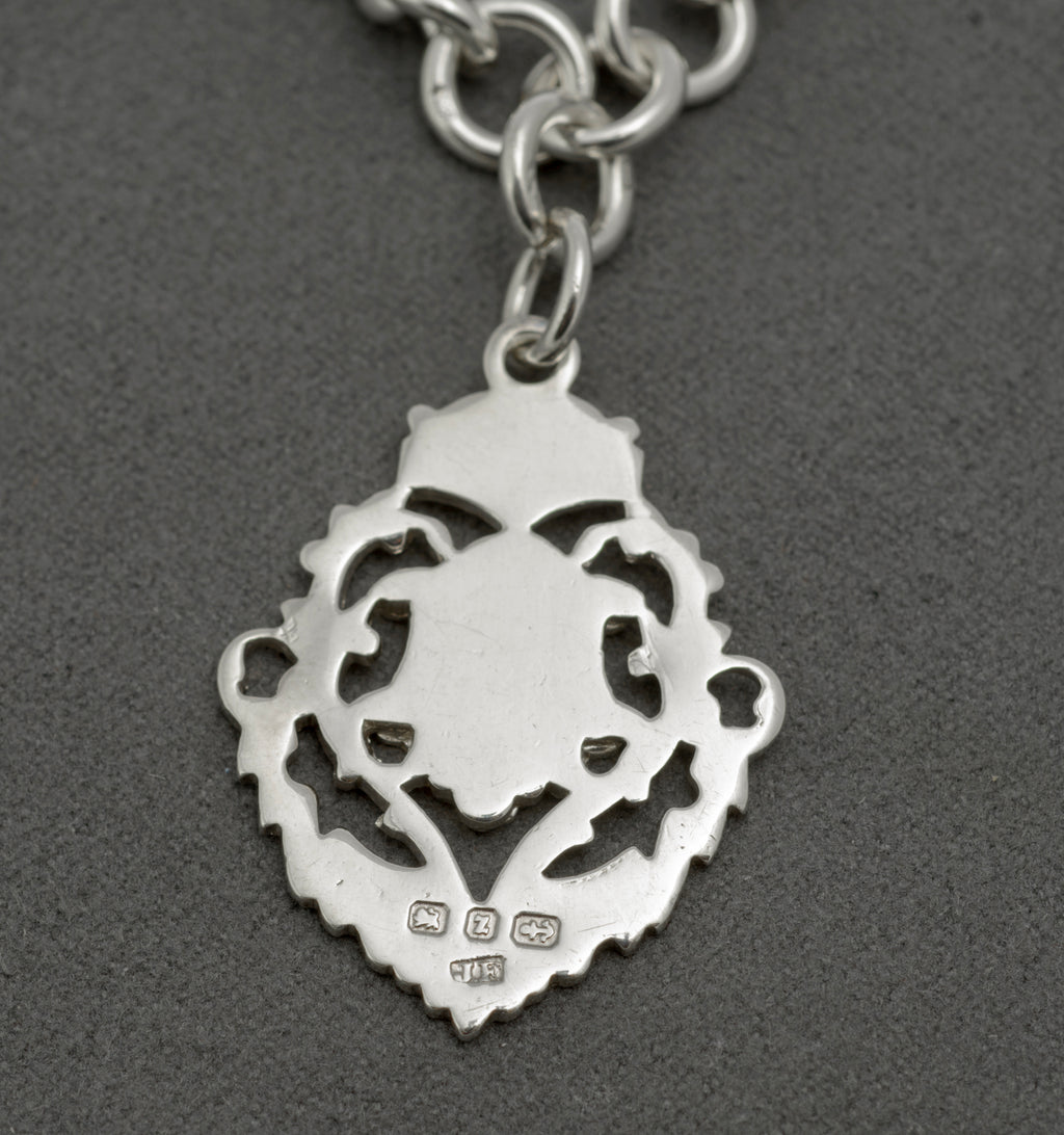 Antique sterling silver Albert watch chain close up of T bar showing hallmarks, attached to chain with ring