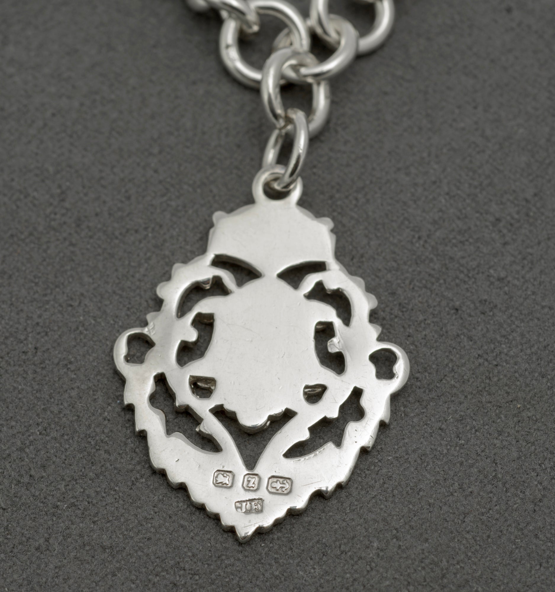 Antique sterling silver Albert watch chain close up of T bar showing hallmarks, attached to chain with ring