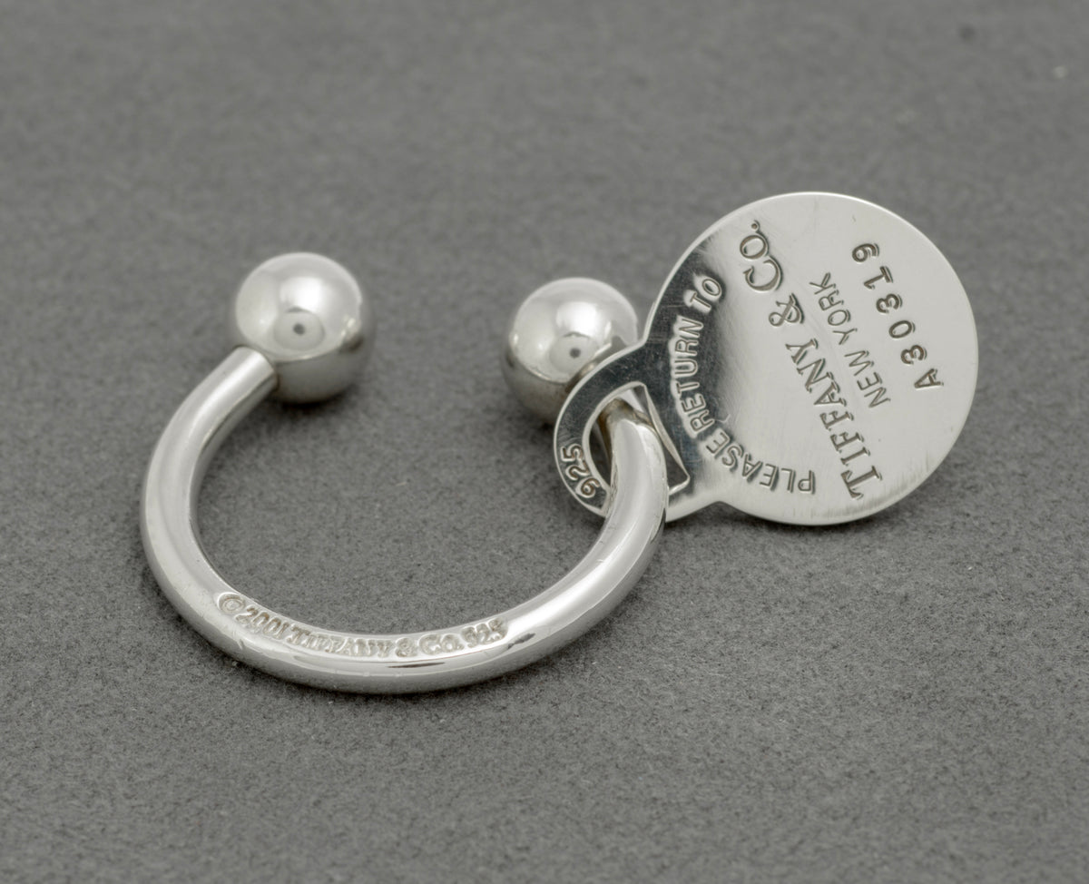 Tiffany and Co sterling silver screwball key ring reverse view showing tag with Please Return to Tiffany and Co New York text and ring marked copyright 2001 Tiffany and Co 925