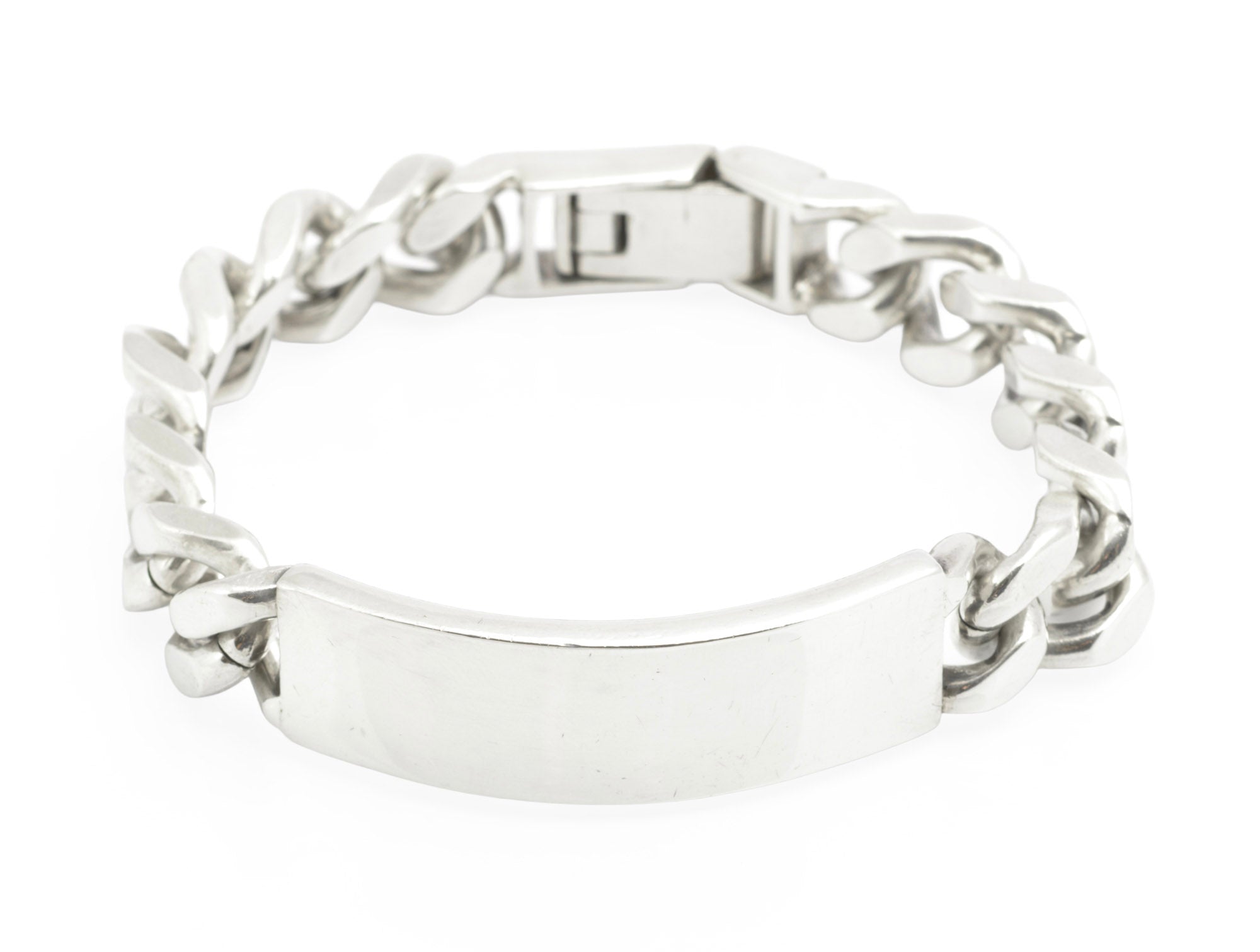 Vintage sterling silver ID bracelet side profile view on white background showing plain ID panel, broad curb links and clasp