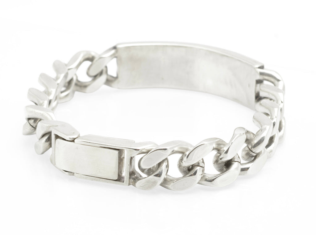 Vintage sterling silver ID bracelet full view on grey background showing broad polished curb links and plain unengraved ID panel