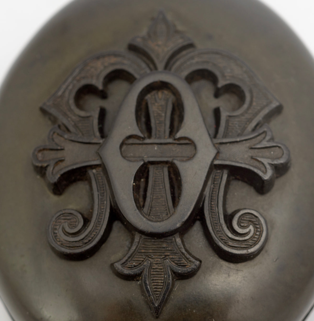 Antique Victorian vulcanite mourning locket open view second angle showing brass retaining rings and interior foliate engraving in both halves