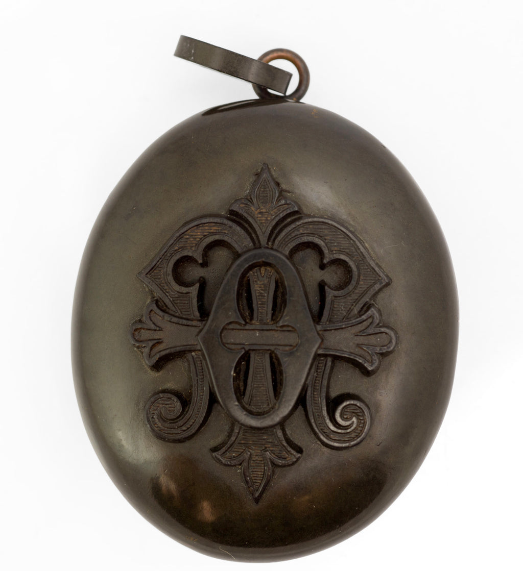 Antique Victorian vulcanite mourning locket rear view showing plain domed reverse and vulcanite suspension loop