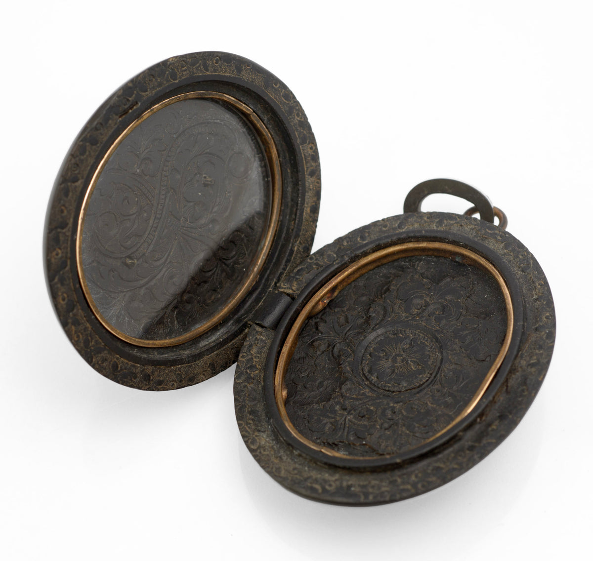 Antique Victorian vulcanite mourning locket detail of brass hinge pin and body edge showing slight olive tone to vulcanite surface