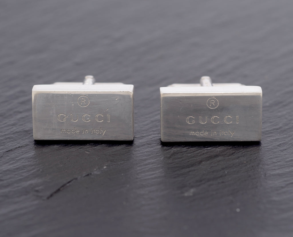 Vintage Gucci Trademark sterling silver cufflinks pair front view showing engraved Gucci Made in Italy branding on polished rectangular heads