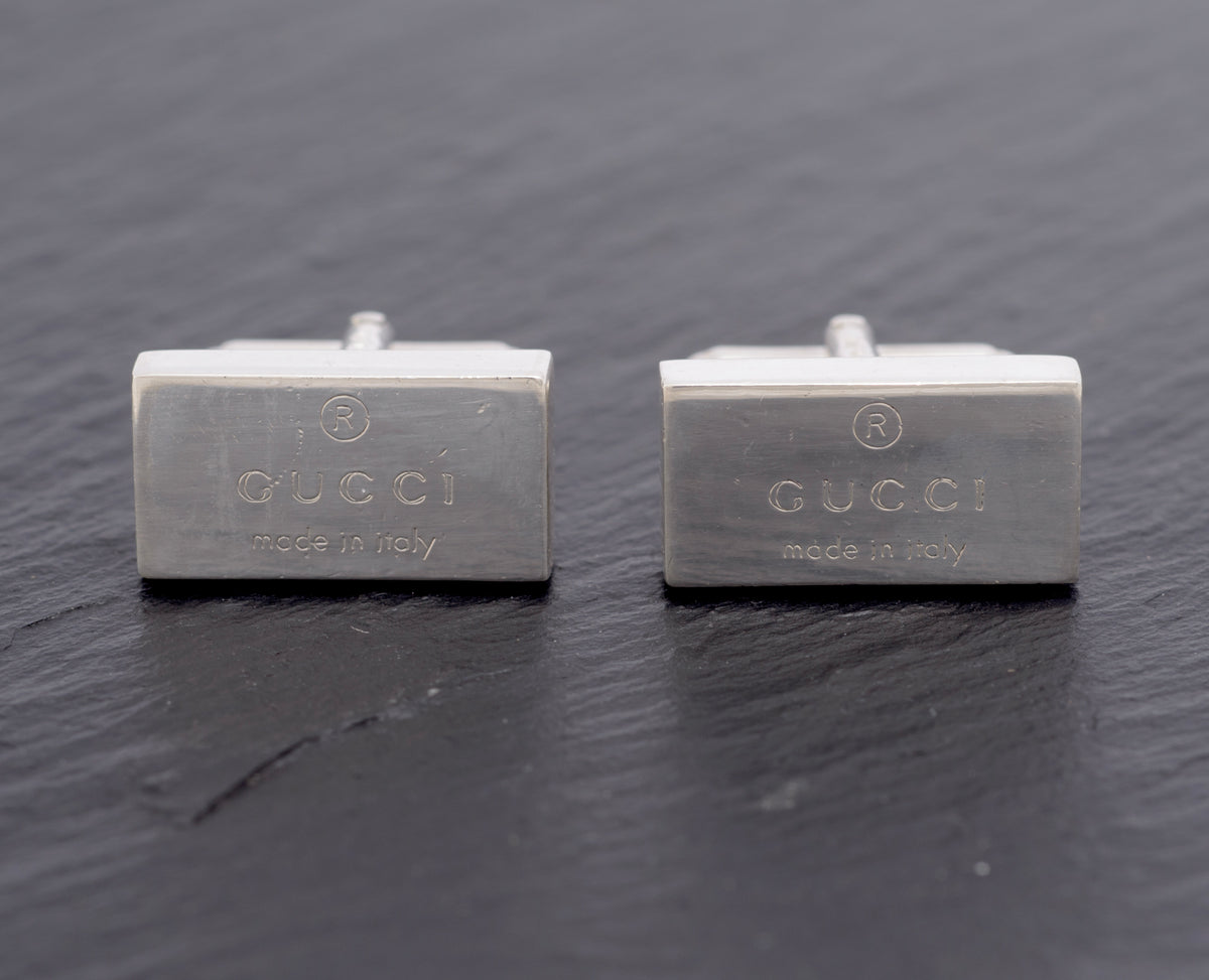 Vintage Gucci Trademark sterling silver cufflinks pair front view showing engraved Gucci Made in Italy branding on polished rectangular heads