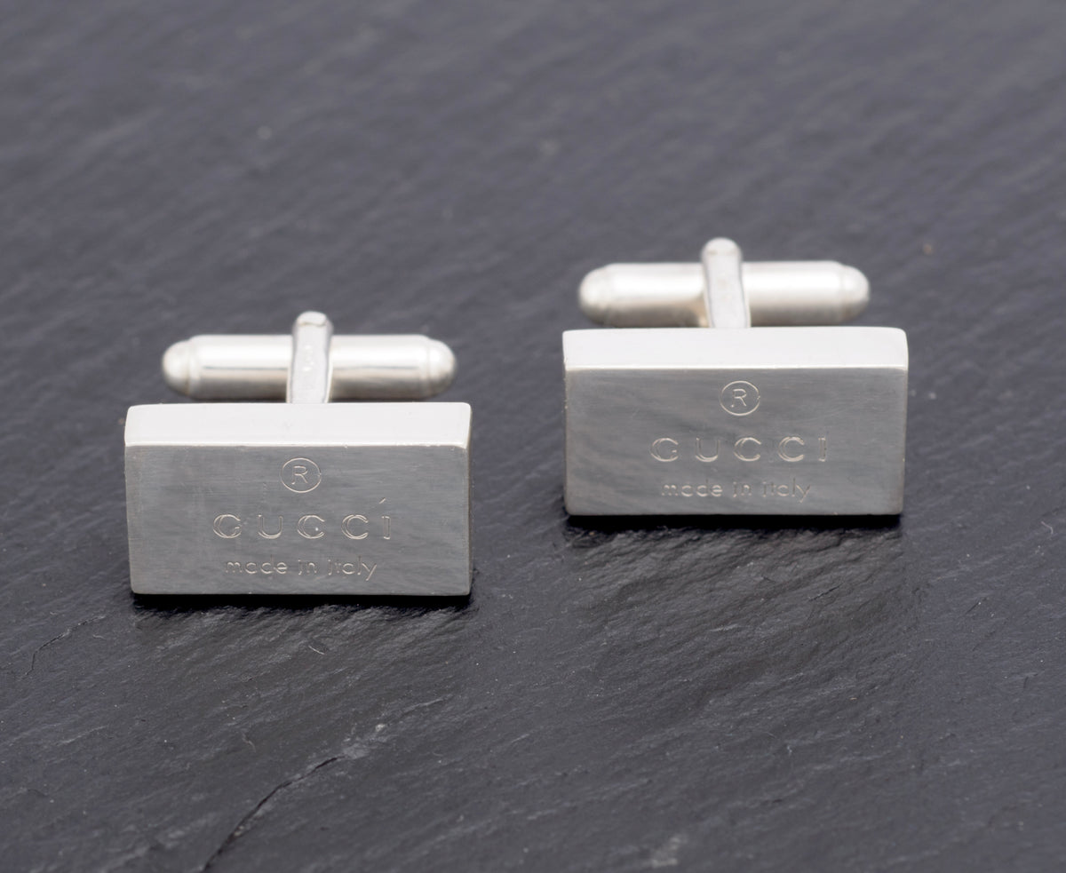 Vintage Gucci Trademark sterling silver cufflinks pair angled view showing swivel bar toggle fittings and depth of rectangular slab heads