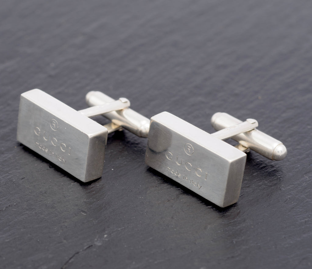 Vintage Gucci Trademark sterling silver cufflinks pair side angle view showing bevelled edges and swivel toggle fittings extended