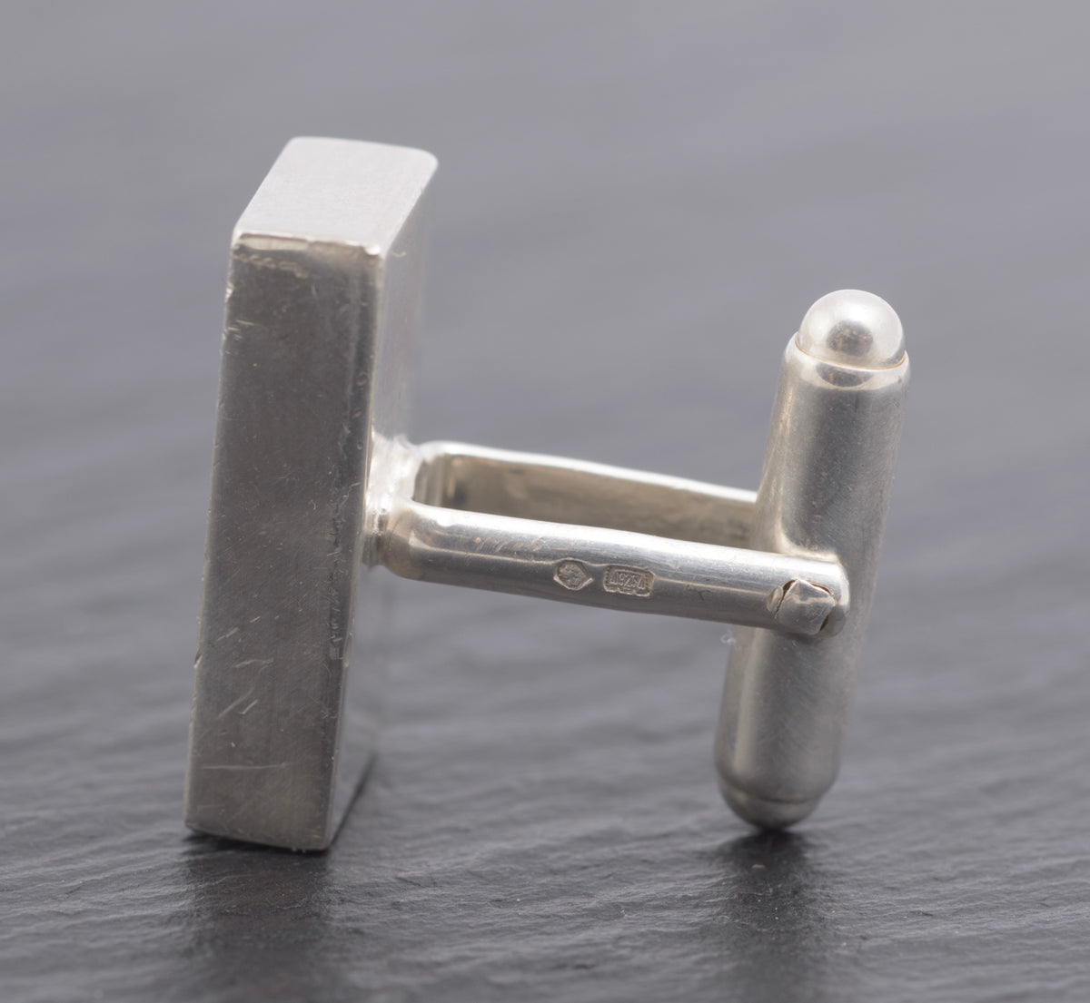 Vintage Gucci Trademark sterling silver cufflink single close up side view showing 925 and Italian assay marks on post with Swiss St. Bernard hallmark