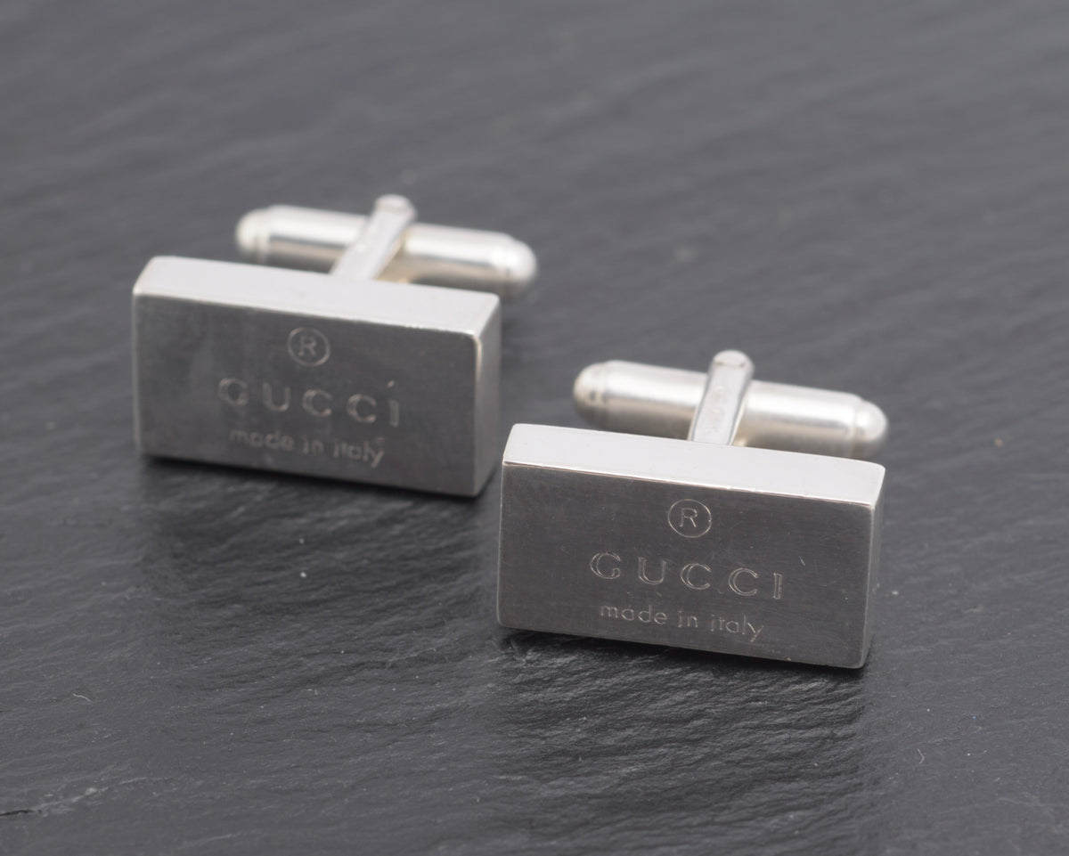 Vintage Gucci Trademark sterling silver cufflinks pair angled view showing both heads with Gucci engraving and swivel fittings in open position