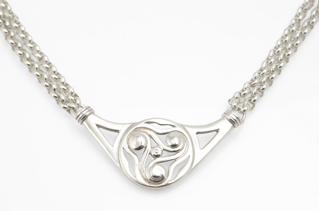 Vintage Ola Gorie sterling silver triskelion necklet full view on white background showing openwork centre and double rolo chain