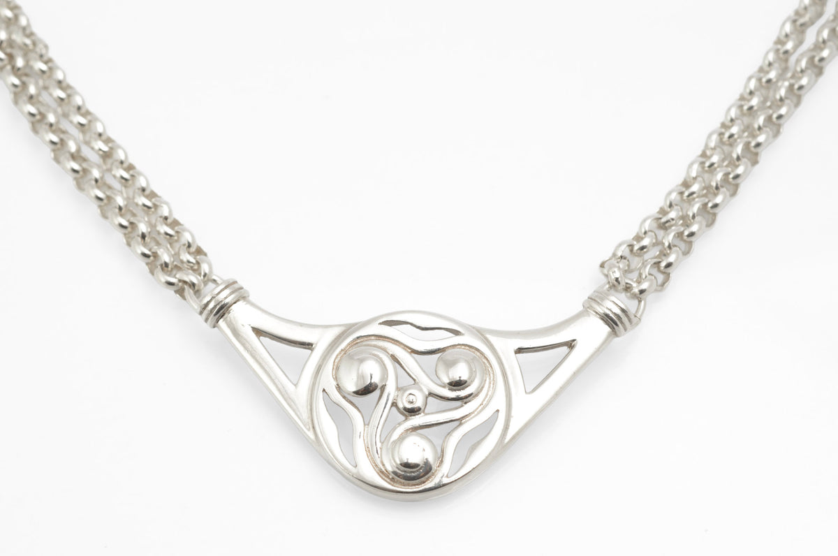 Vintage Ola Gorie sterling silver triskelion necklet full view on white background showing openwork centre and double rolo chain