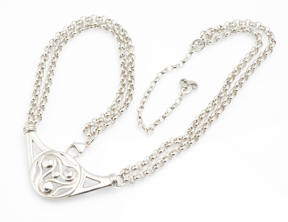 Vintage Ola Gorie sterling silver necklet close up of small triskelion extension charm marked OMG St Sil on white background