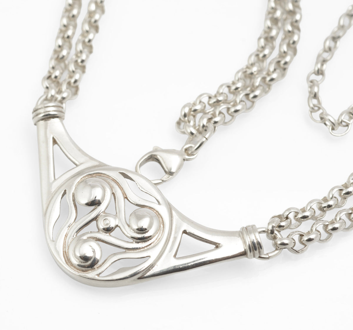 Vintage Ola Gorie sterling silver necklet full view on grey background showing double rolo chain, openwork triskelion centre and lobster clasp