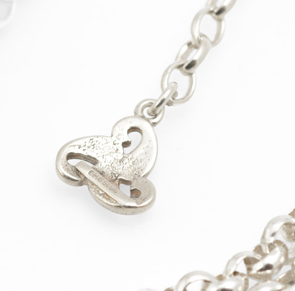 Vintage Ola Gorie sterling silver necklet close up of lobster clasp and double rolo chain on grey background