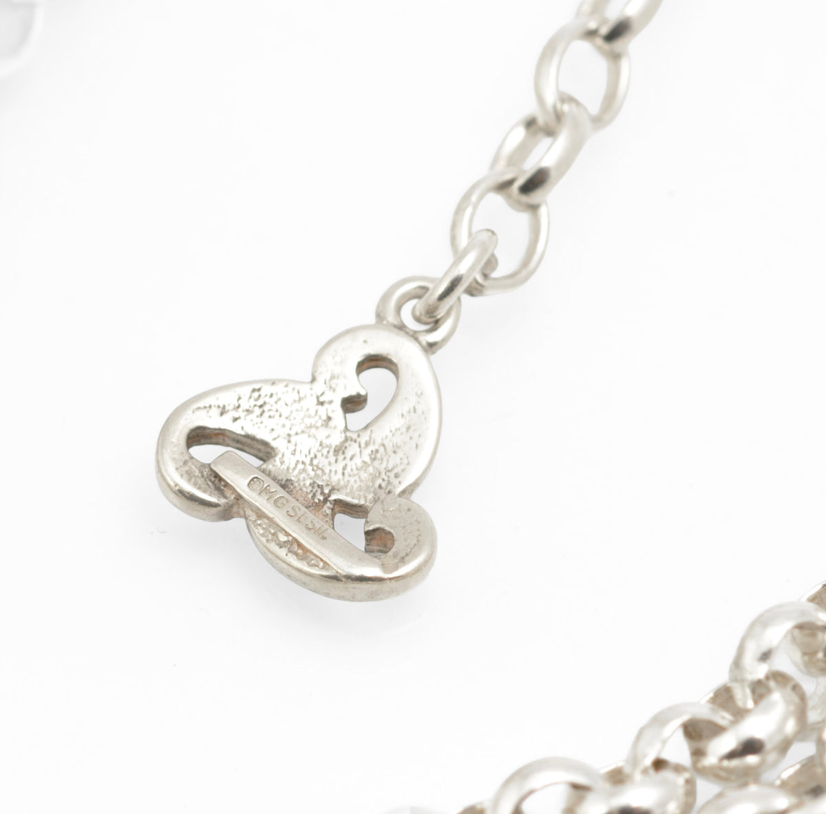Vintage Ola Gorie sterling silver necklet close up of lobster clasp and double rolo chain on grey background