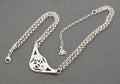 Vintage Ola Gorie sterling silver necklet full laid flat view on grey background showing adjustable extension chain and triskelion terminal charm