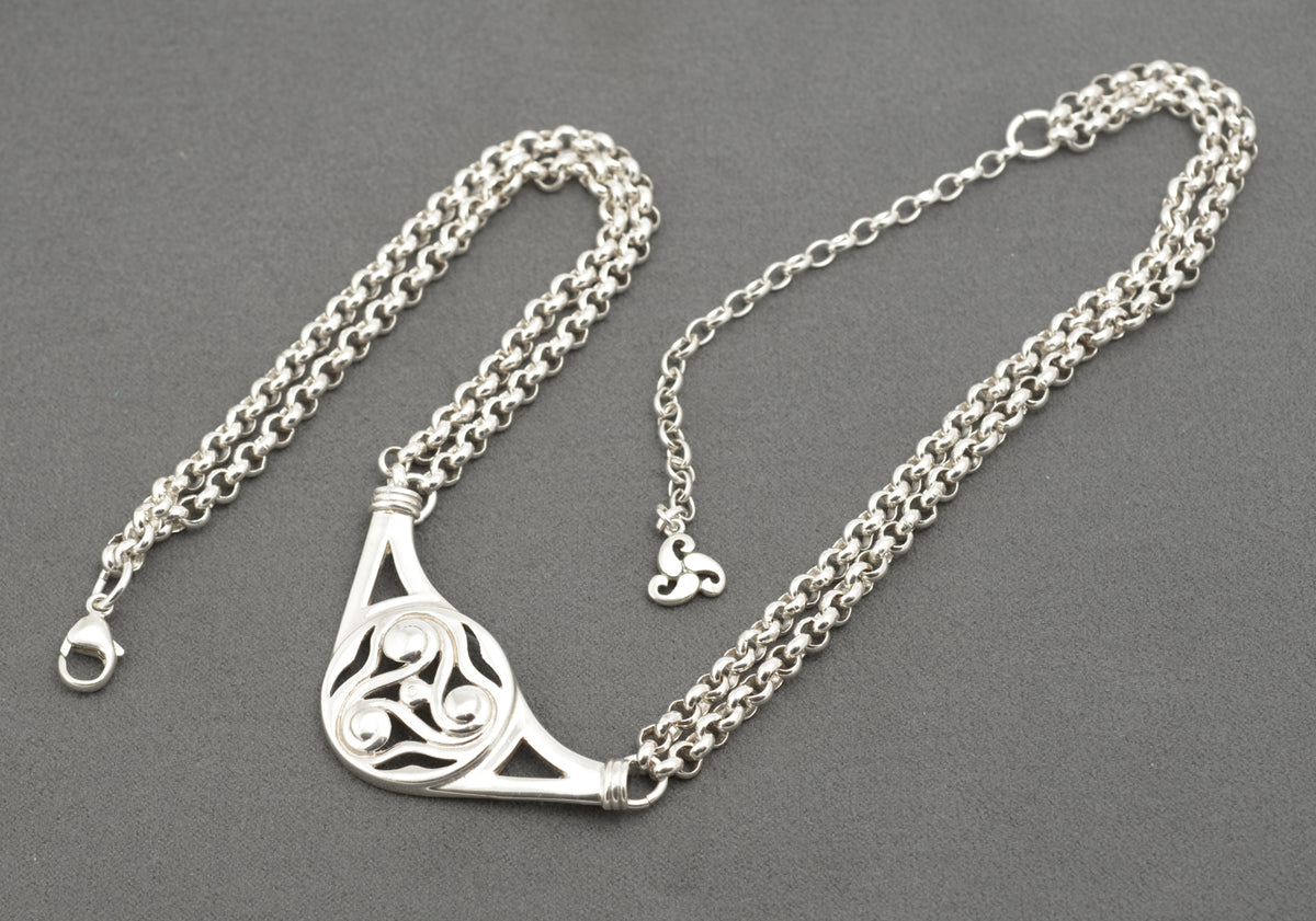 Vintage Ola Gorie sterling silver necklet full laid flat view on grey background showing adjustable extension chain and triskelion terminal charm