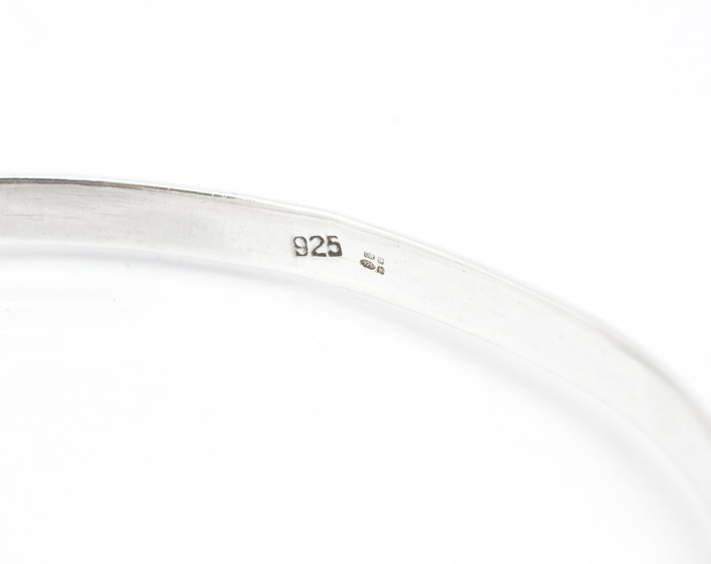 Vintage sterling silver amethyst bangle, open bangle form with oval bezel set cabochon and articulated side connections