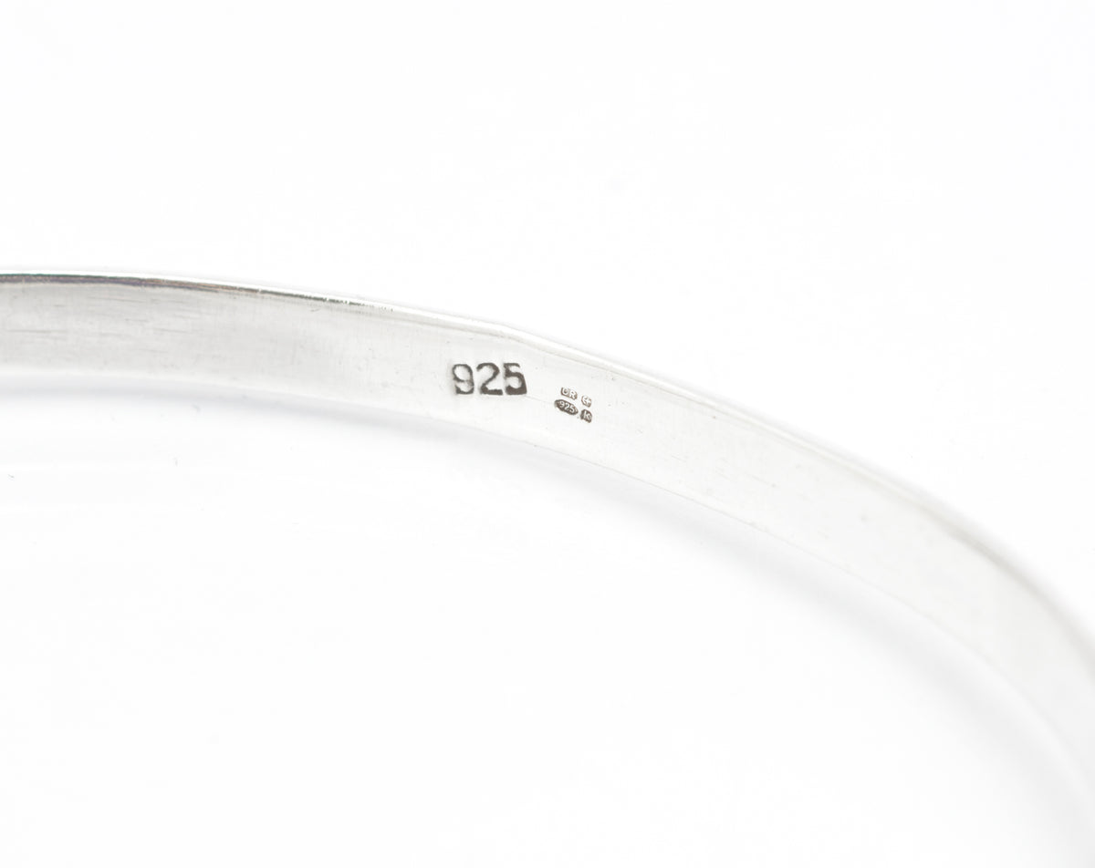 Vintage sterling silver amethyst bangle, open bangle form with oval bezel set cabochon and articulated side connections