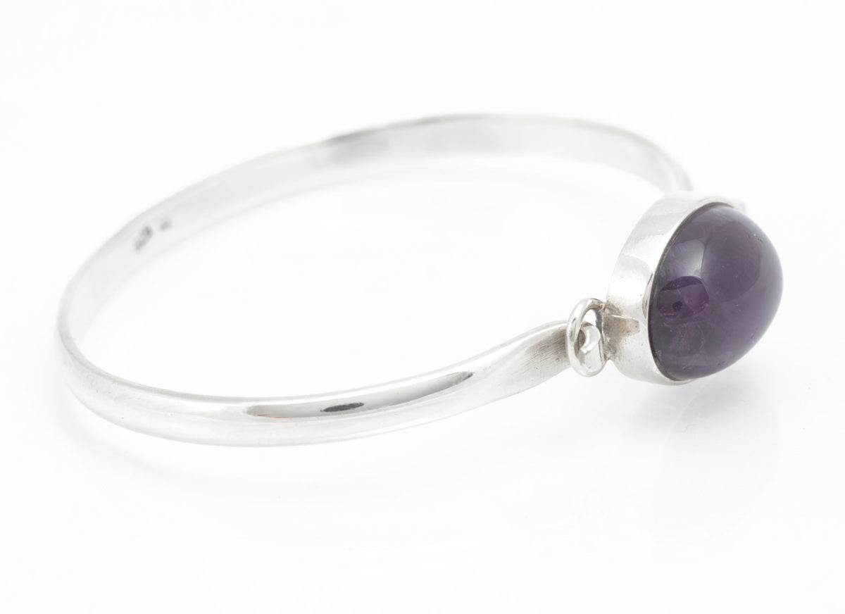 Sterling silver amethyst cabochon bangle showing open ends and bezel setting from the reverse