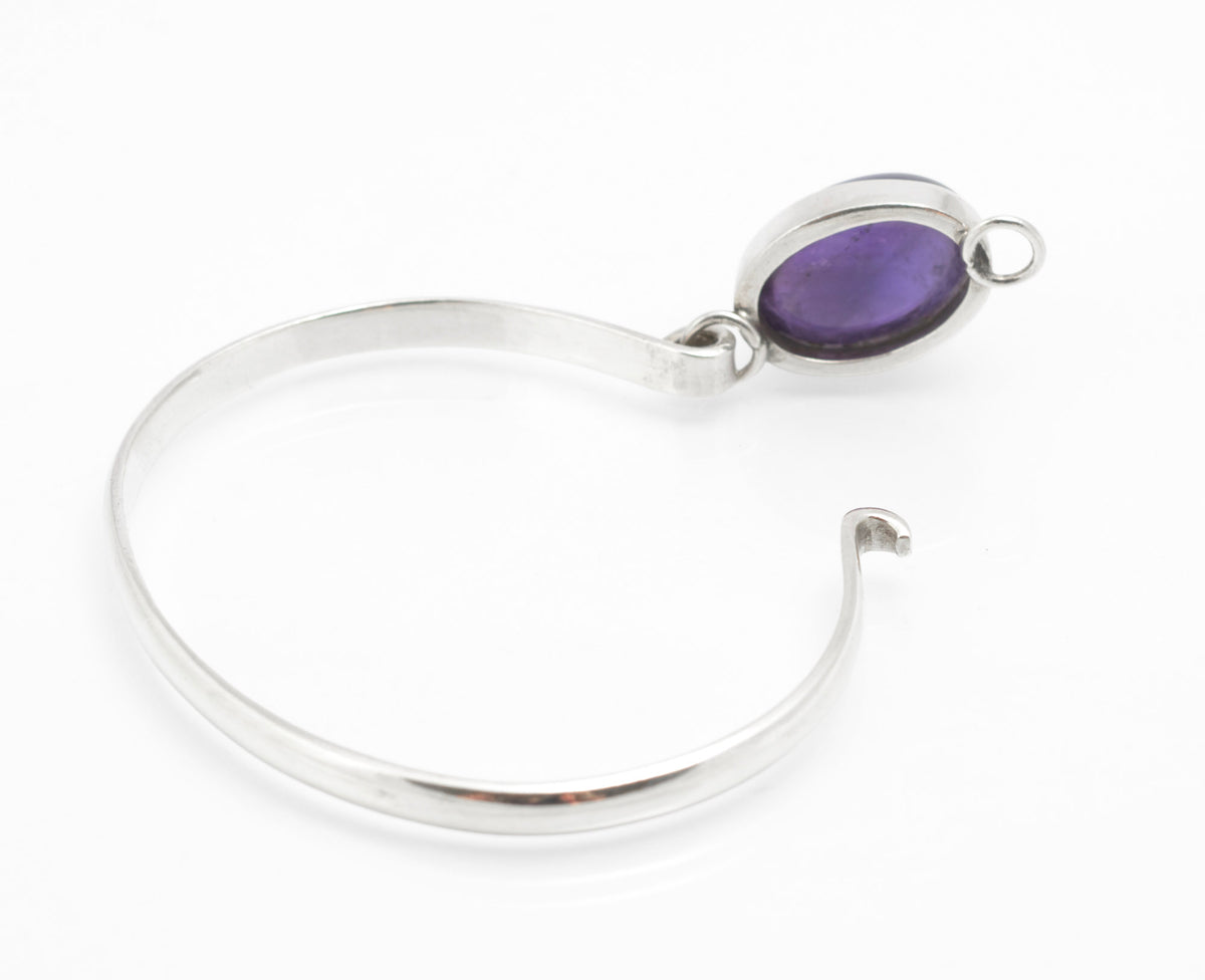 Sterling silver amethyst bangle with bezel set cabochon, shown from the reverse and side