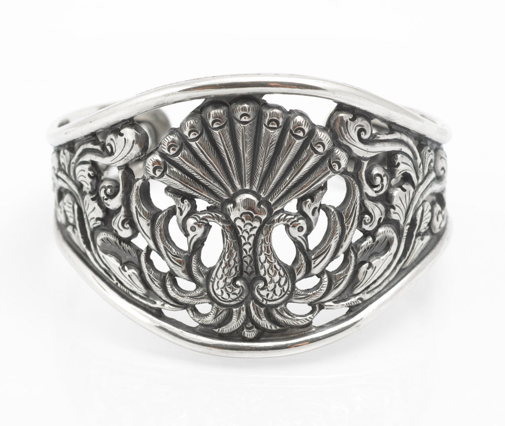 Vintage Yogya 800 silver cuff bangle angled view showing pierced peacock and scrolling foliate openwork with dark patination
