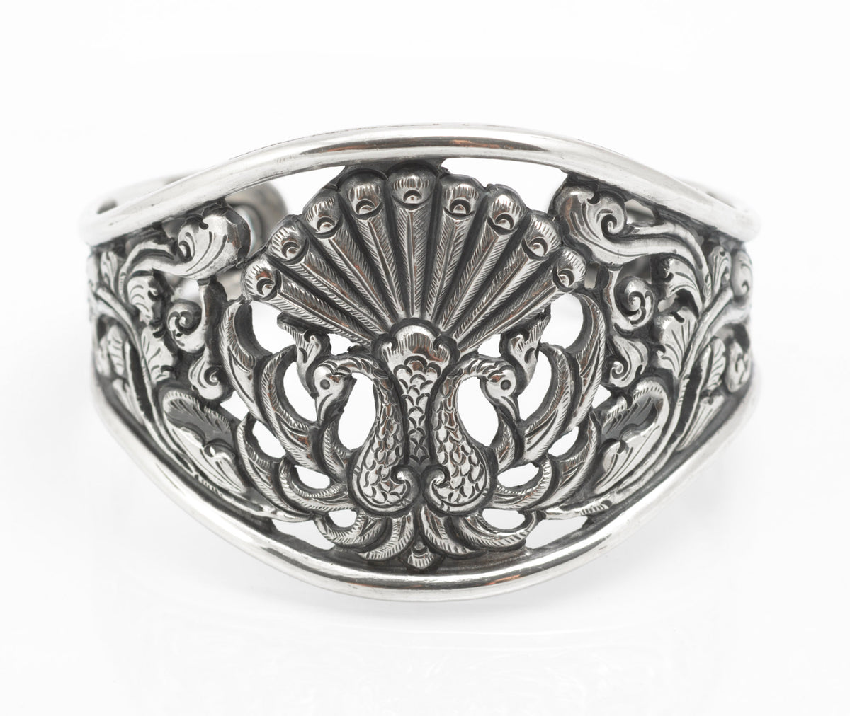 Vintage Yogya 800 silver cuff bangle angled view showing pierced peacock and scrolling foliate openwork with dark patination