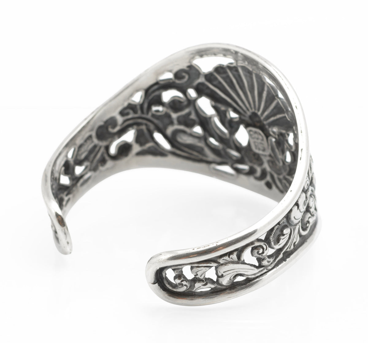 Vintage Yogya 800 silver cuff bangle top down view showing twin peacocks beneath fanned tail with scrolling foliage surround