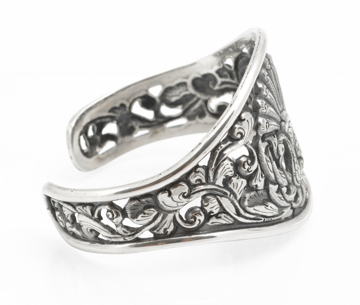 Vintage Yogya 800 silver cuff bangle close up of peacock centre showing engraved feathering and chased foliate detail