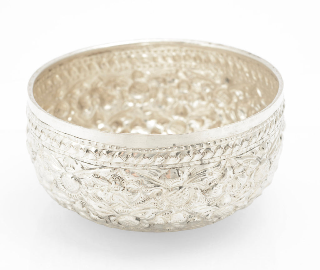 Thai silver offering bowl showing raised floral and foliate repousse decoration