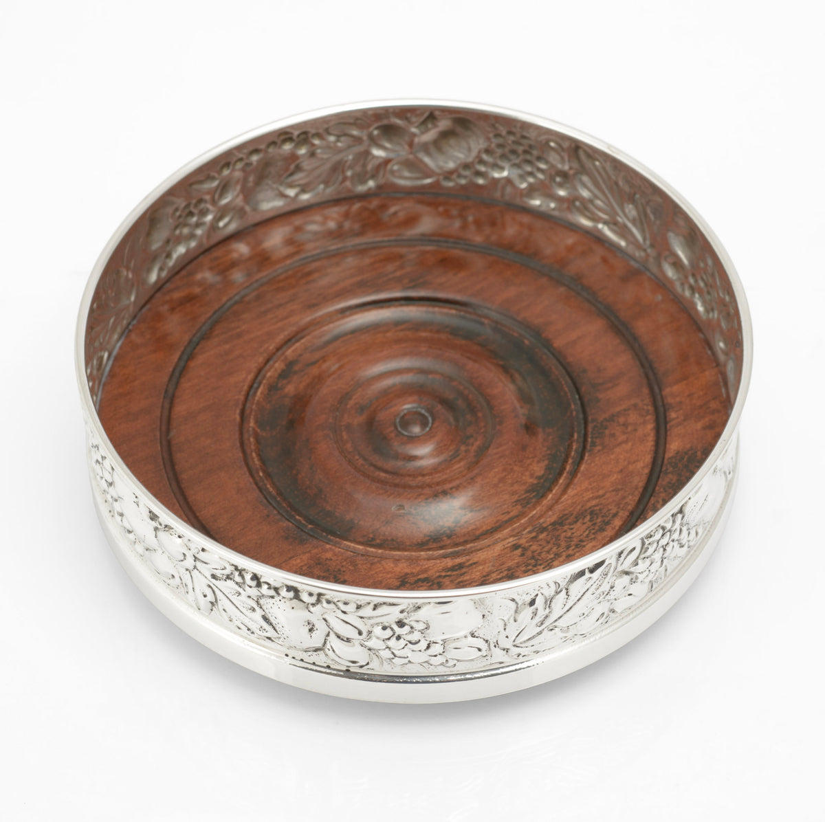 Sterling silver repousse bottle coaster by Falsini Ferruccio Florence, turned hardwood base with concentric rings and central boss - interior view from above