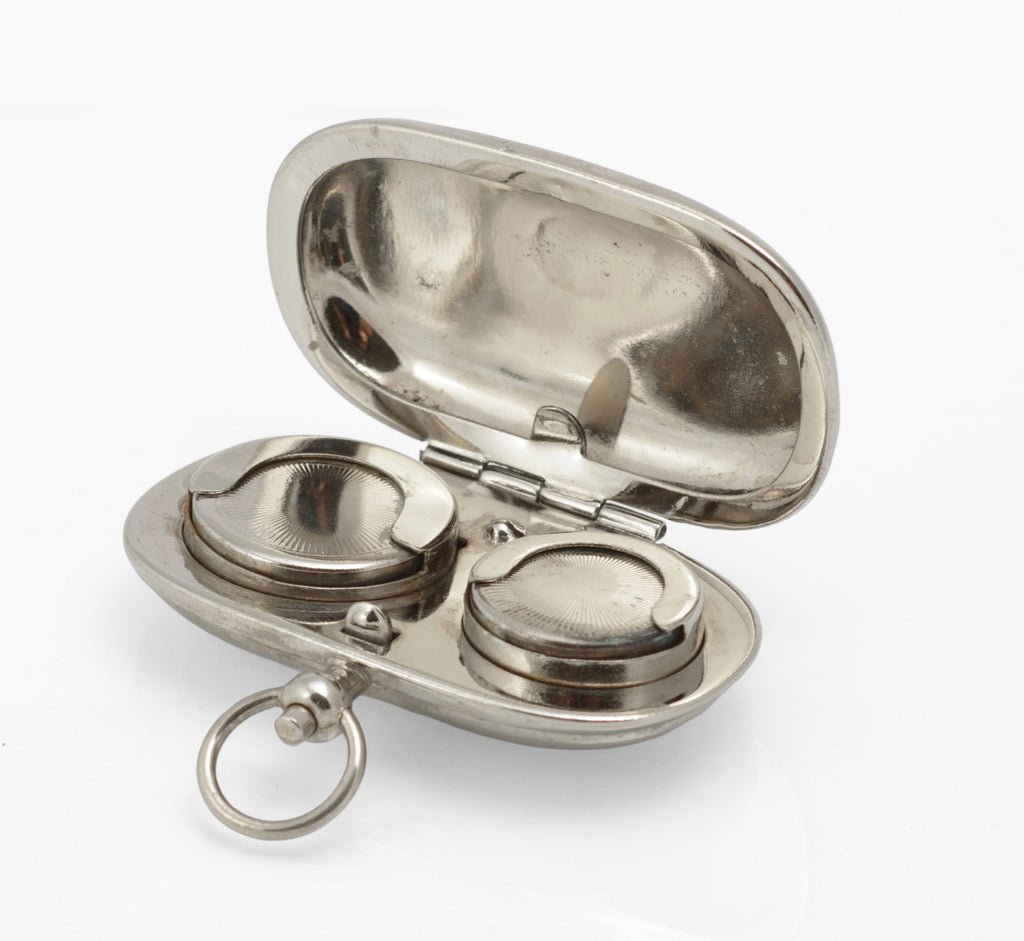 Open antique silver plated double sovereign case showing spaces for a full sovereign and a half sovereign