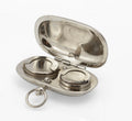 Open antique silver plated double sovereign case showing spaces for a full sovereign and a half sovereign