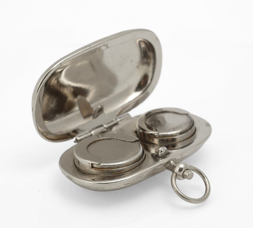 Closed silver plated double sovereign holder showing the rounded rectangular body and suspension ring