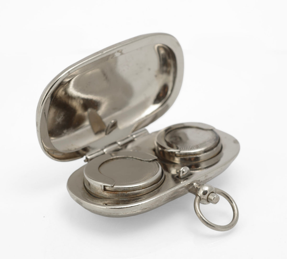 Closed silver plated double sovereign holder showing the rounded rectangular body and suspension ring