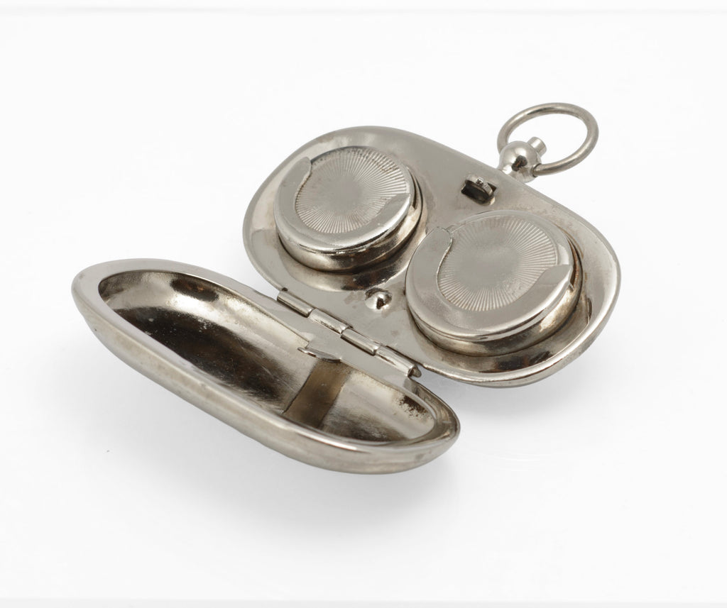 Open antique sovereign case with lid raised, showing the reflective plated interior and fitted compartments