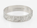 Vintage sterling silver hinged bangle by Bracelon Ltd Birmingham 1978, engraved scrolling foliage with feature hallmarks - front view