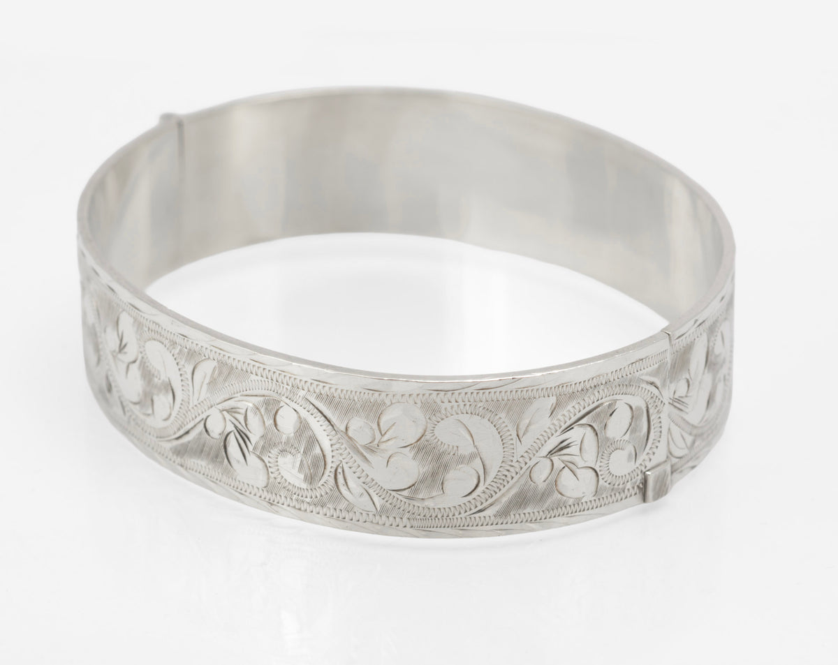Sterling silver Bracelon Ltd bangle showing scrolling foliage engraving and feature hallmarks - rear exterior view