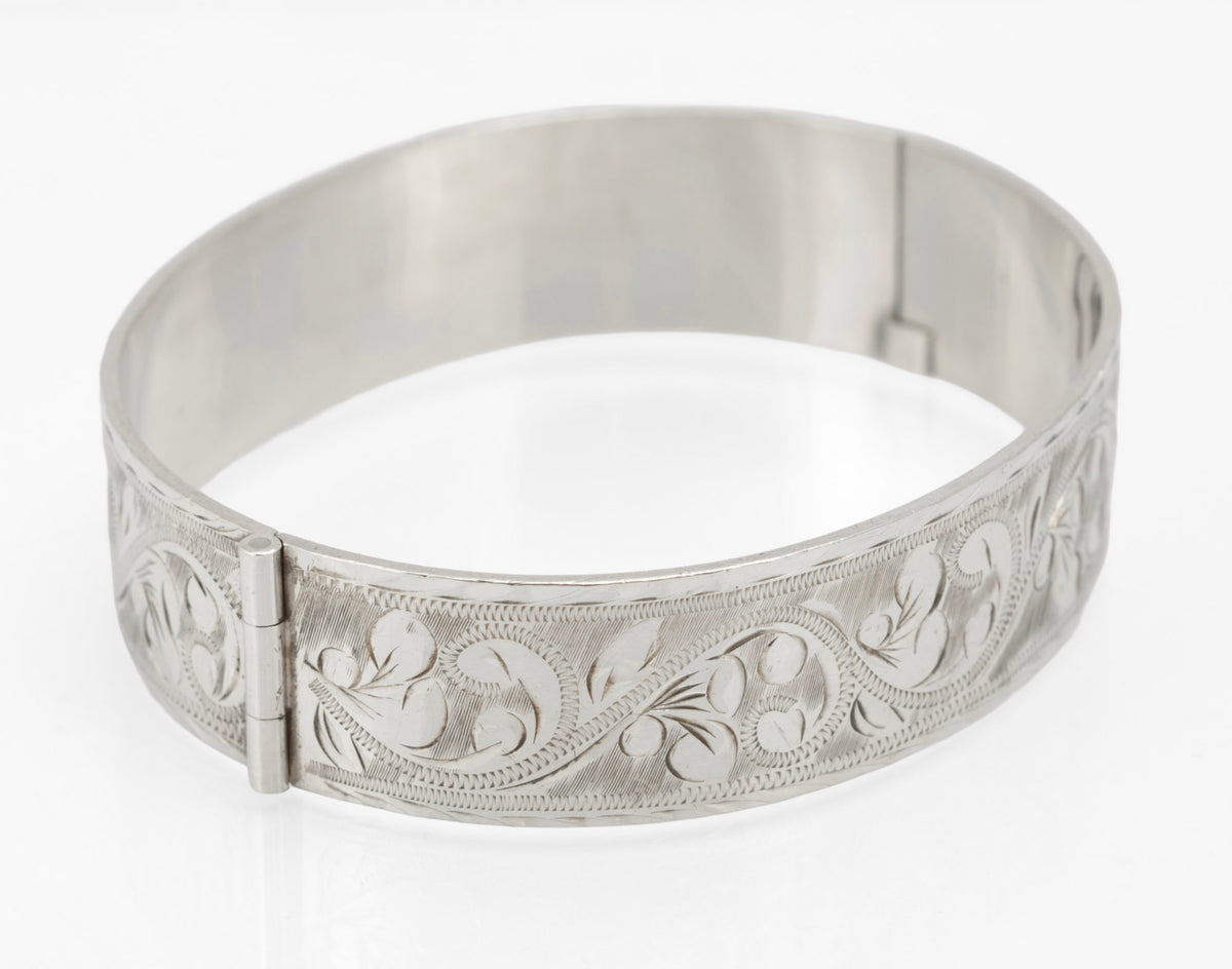 Vintage sterling silver Bracelon Ltd bangle Birmingham 1978, feature hallmarks incorporated into engraved decoration - front view