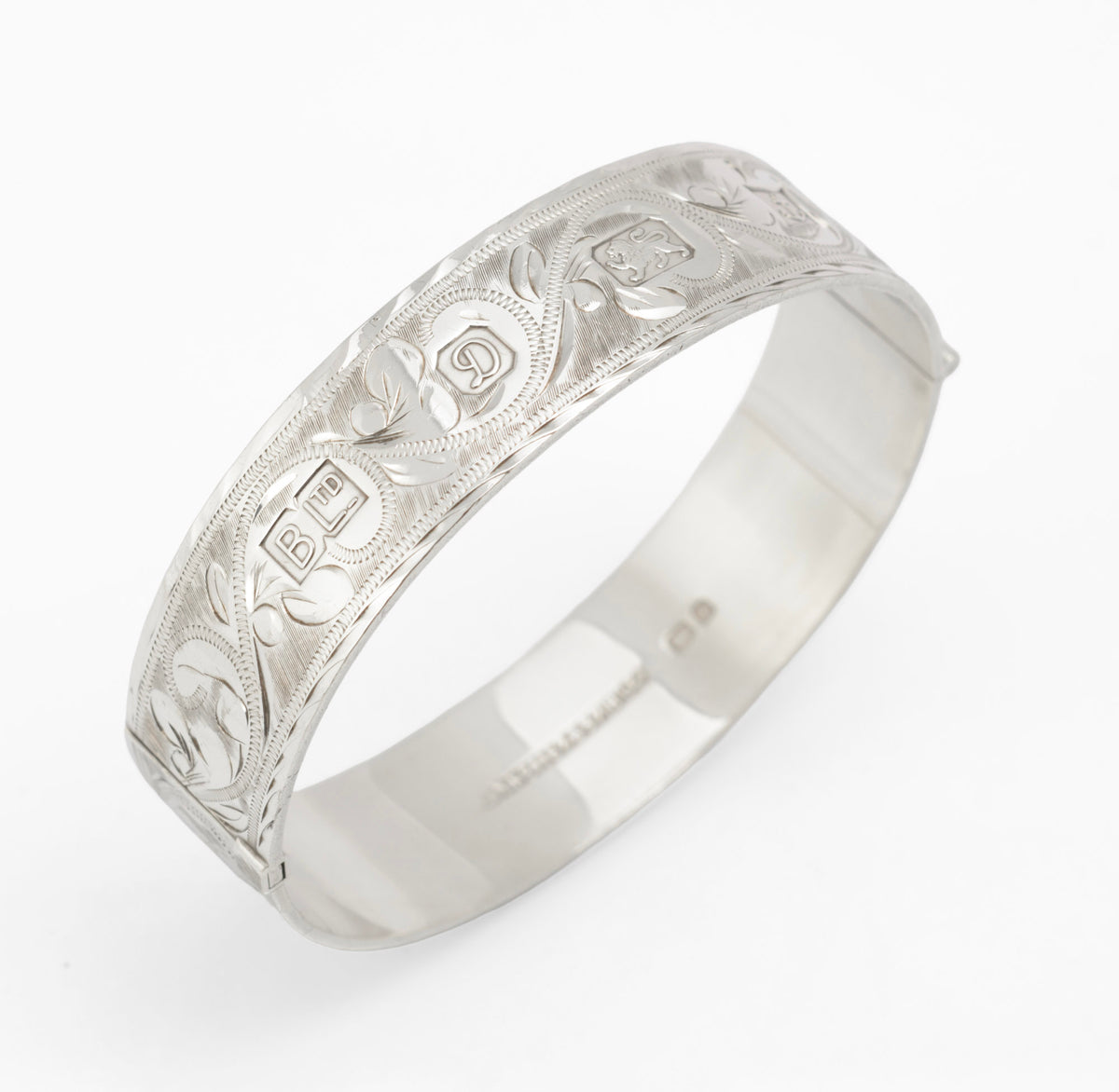 Sterling silver Bracelon Ltd bangle, angled view showing plain inner band and exterior engraving