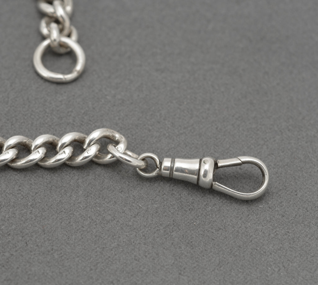 Antique sterling silver double Albert watch chain laid out with T bar, watch hook and terminal jump ring